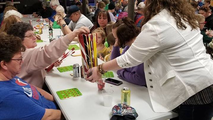 Neighbors gathered around tables for community bingo night