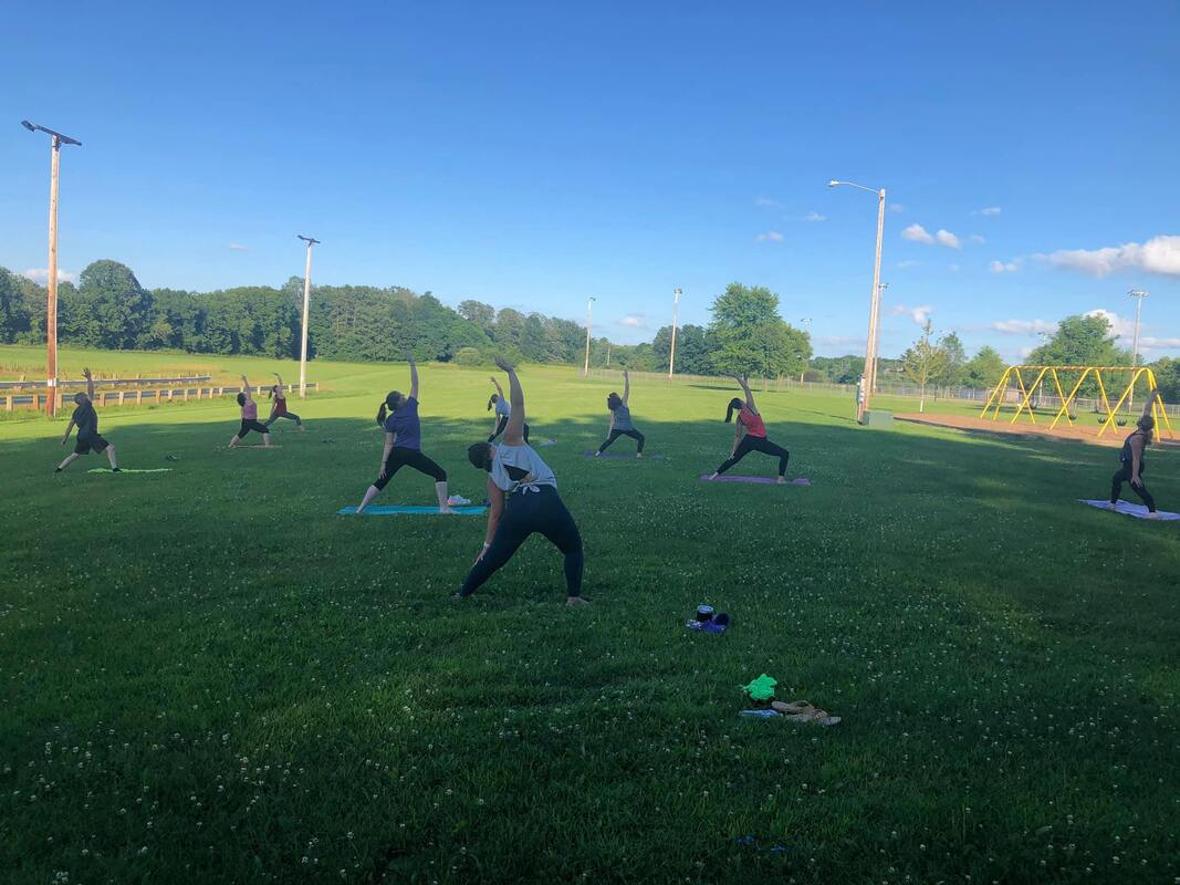 Group yoga session in Riverview Park