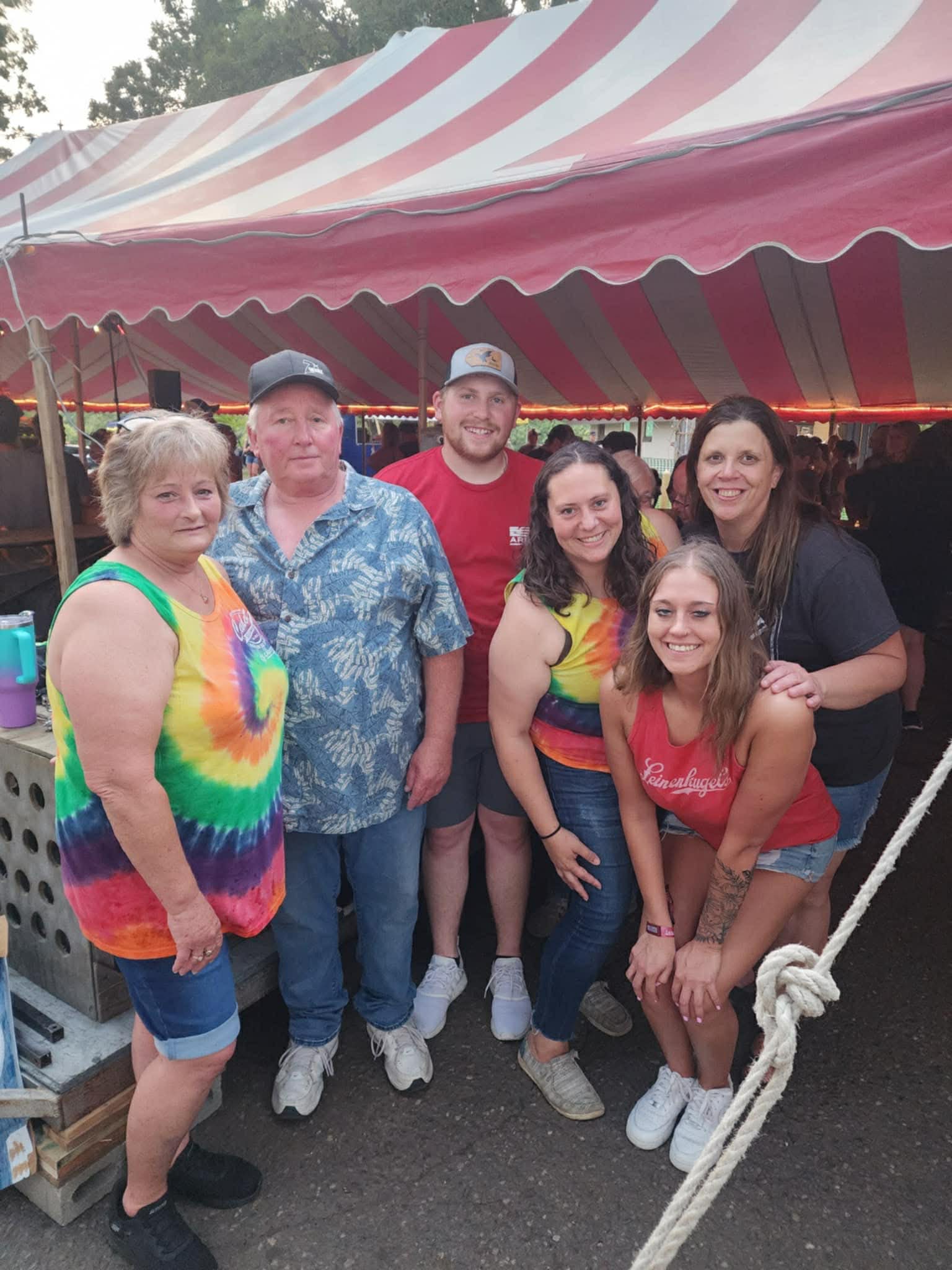 Friends gathered under the Nabor Days beer tent at night