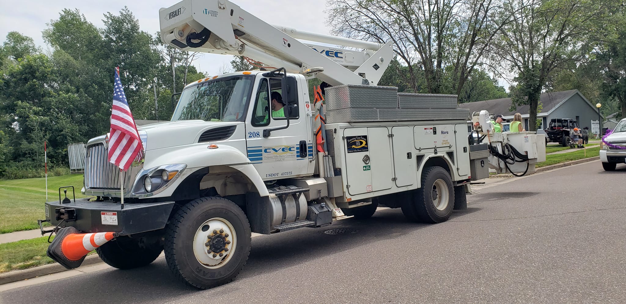 Chippewa Valley Electric Cooperative bucket truck with American flag in the parade