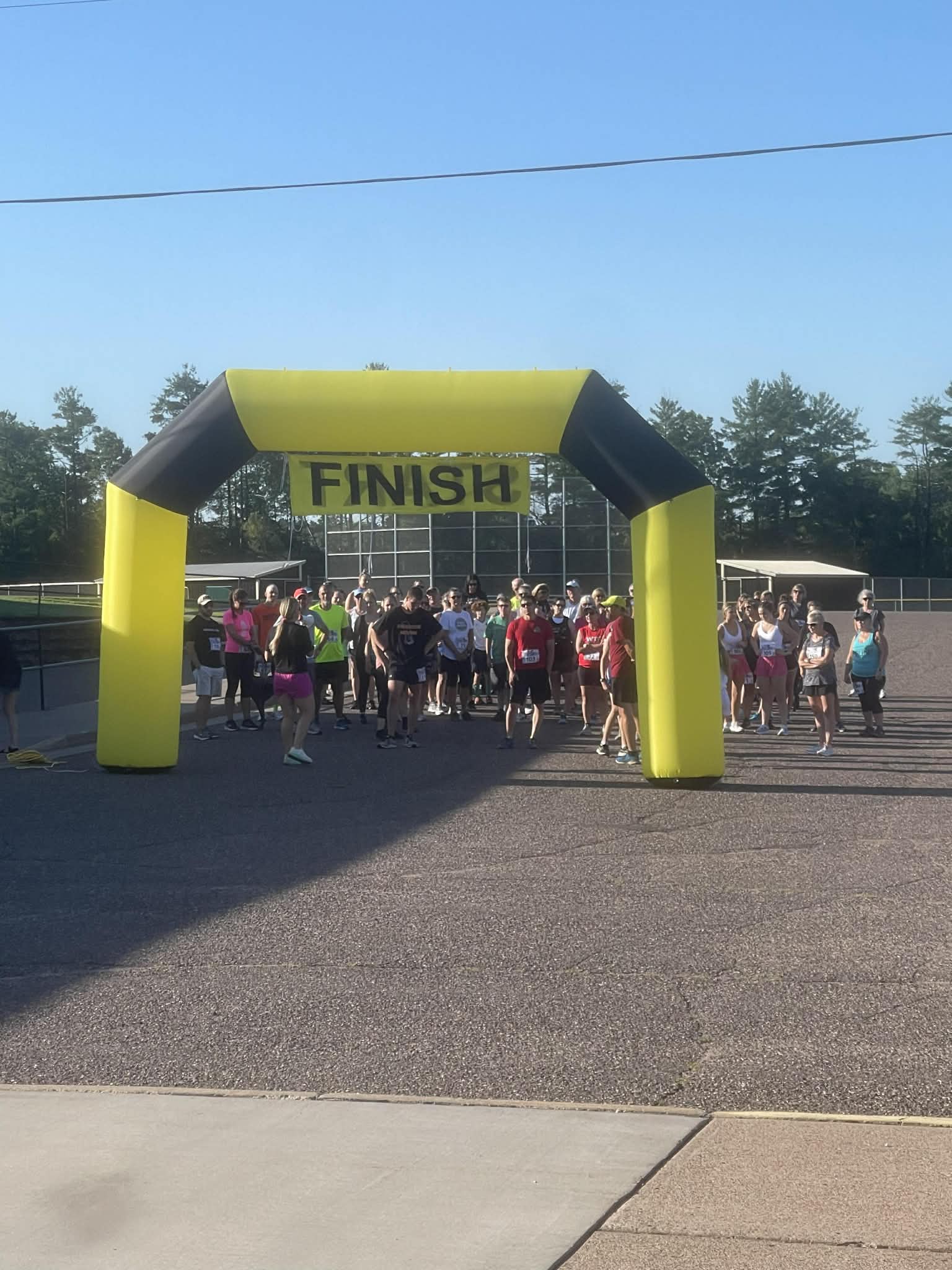 Runners gathering under the Finish arch at the 2025 Fun Run